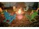 Cozy backyard fire pit with Adirondack chairs, ideal for outdoor gatherings and relaxing evenings at 22396 Nyack Ave, Port Charlotte, FL 33952