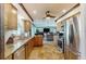 Well-lit kitchen featuring wood cabinets, granite counters, and stainless steel appliances at 22396 Nyack Ave, Port Charlotte, FL 33952