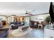 Open-concept living room with hardwood floors, cozy furniture, and abundant natural light at 22396 Nyack Ave, Port Charlotte, FL 33952