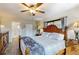 Bright main bedroom features a ceiling fan, wood flooring, and ensuite bath at 22396 Nyack Ave, Port Charlotte, FL 33952