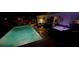 Backyard pool and hot tub combination, with a spacious patio and seating area illuminated at night at 22396 Nyack Ave, Port Charlotte, FL 33952