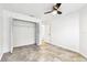 Bedroom with tile flooring, a closet with louvered doors, and a ceiling fan at 232 Hunter Ct, Palm Harbor, FL 34684