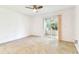 Bright bedroom featuring tile flooring, ceiling fan, and sliding glass door to the patio at 232 Hunter Ct, Palm Harbor, FL 34684