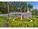 Steeplechase Town Homes entrance features a fountain, landscaping, and community sign at 232 Hunter Ct, Palm Harbor, FL 34684