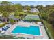 Aerial shot of the community pool, deck, furniture, tennis courts and well-kept grounds at 232 Hunter Ct, Palm Harbor, FL 34684