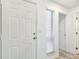 Bright entryway featuring a white front door, window with blinds, and view into the hallway at 232 Hunter Ct, Palm Harbor, FL 34684