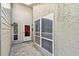 View of a white patio door and window beside the white exterior wall of the villa at 232 Hunter Ct, Palm Harbor, FL 34684