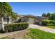 Charming villa featuring a one-car garage, a private gated courtyard, and lush landscaping in a desirable community at 232 Hunter Ct, Palm Harbor, FL 34684