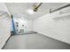 Spacious two-car garage with white walls, storage racks, and gray epoxy flooring at 232 Hunter Ct, Palm Harbor, FL 34684