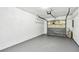 Spacious garage with concrete floor, garage door, shelving and storage for all your tools and equipment at 232 Hunter Ct, Palm Harbor, FL 34684