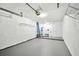 Spacious garage with concrete floor, garage door, water heater, shelving and ladder for all your needs at 232 Hunter Ct, Palm Harbor, FL 34684