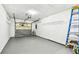Spacious garage with concrete floor, garage door, shelving and ladder for storing all your tools and equipment at 232 Hunter Ct, Palm Harbor, FL 34684