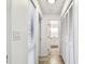 Hallway with tile flooring and a view of the bathroom and closet with white louvered doors at 232 Hunter Ct, Palm Harbor, FL 34684