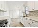 Modern kitchen features white cabinets and stylish backsplash at 232 Hunter Ct, Palm Harbor, FL 34684