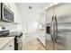 Modern kitchen features white cabinets and stainless steel appliances at 232 Hunter Ct, Palm Harbor, FL 34684