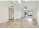 Bright living room features neutral tile flooring, high ceilings, and sliding glass doors to the patio at 232 Hunter Ct, Palm Harbor, FL 34684