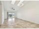 Bright living room with neutral tile floors, modern ceiling fan, and access to the screened patio at 232 Hunter Ct, Palm Harbor, FL 34684