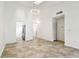 Bright living room features neutral tile flooring and modern light fixtures at 232 Hunter Ct, Palm Harbor, FL 34684