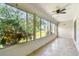 Enclosed patio with many windows to let in natural light and a ceiling fan at 232 Hunter Ct, Palm Harbor, FL 34684