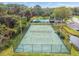 Community aerial showcasing tennis court, pool, and lush surrounding landscape at 232 Hunter Ct, Palm Harbor, FL 34684