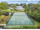 Aerial shot showing tennis court, pond and landscaping within the community at 232 Hunter Ct, Palm Harbor, FL 34684