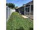 A view of the backyard with green grass and a white fence at 2603 Valencia Grove Dr, Valrico, FL 33596