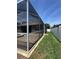 An enclosed pool and view of the backyard with green grass and a white fence at 2603 Valencia Grove Dr, Valrico, FL 33596