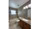 Well-lit bathroom featuring a granite countertop vanity and shower-tub combo with decorative tile accents at 2603 Valencia Grove Dr, Valrico, FL 33596