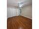 Bedroom featuring hardwood floors, a ceiling fan, and a closet area for optimal storage solutions at 2603 Valencia Grove Dr, Valrico, FL 33596