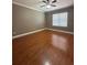 A well-lit bedroom with wood floors and a ceiling fan at 2603 Valencia Grove Dr, Valrico, FL 33596