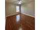 Simple yet cozy bedroom featuring hardwood floors and natural light from the large window at 2603 Valencia Grove Dr, Valrico, FL 33596
