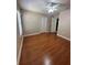 Comfortable bedroom features hardwood floors, a ceiling fan, and ample closet space for storage at 2603 Valencia Grove Dr, Valrico, FL 33596