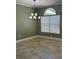 Charming dining area featuring an elegant chandelier and a large window for natural lighting at 2603 Valencia Grove Dr, Valrico, FL 33596