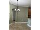 Dining area featuring modern chandelier, neutral paint, and tile flooring at 2603 Valencia Grove Dr, Valrico, FL 33596
