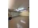 Spacious two car garage featuring epoxy flooring and ample room for parking and storage at 2603 Valencia Grove Dr, Valrico, FL 33596