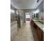 A spacious bathroom with granite counters, tile floors, and a walk-in shower at 2603 Valencia Grove Dr, Valrico, FL 33596