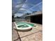 Enclosed pool area with a swimming pool and connected jacuzzi tub, with a brick patio area at 2603 Valencia Grove Dr, Valrico, FL 33596