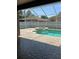 Screened-in pool area with a jacuzzi and waterfall feature; brick patio and white fencing at 2603 Valencia Grove Dr, Valrico, FL 33596