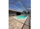 A screened-in pool with a brick patio at 2603 Valencia Grove Dr, Valrico, FL 33596