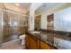 Bathroom with granite countertop and a glass enclosed shower at 2674 Tanglewood Trl, Palm Harbor, FL 34685