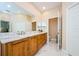 Bright bathroom with a marble countertop, double vanity, and tile floors at 2674 Tanglewood Trl, Palm Harbor, FL 34685