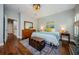 Comfortable bedroom featuring hardwood floors, dresser, and a queen bed at 2674 Tanglewood Trl, Palm Harbor, FL 34685