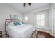 Bright bedroom featuring wood floors, a ceiling fan, and plantation shutters at 2674 Tanglewood Trl, Palm Harbor, FL 34685