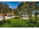 Serene community space with inviting firepit area surrounded by lush greenery and blooming trees at 2674 Tanglewood Trl, Palm Harbor, FL 34685