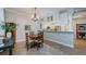 Open concept dining area with chandelier and views to the kitchen with stainless appliances at 2674 Tanglewood Trl, Palm Harbor, FL 34685