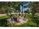 Inviting outdoor firepit with seating, perfect for gatherings and enjoying the serene surroundings at 2674 Tanglewood Trl, Palm Harbor, FL 34685