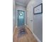 Foyer with custom glass paneled door and neutral walls and tile at 2674 Tanglewood Trl, Palm Harbor, FL 34685