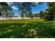 Expansive green space surrounded by a well-maintained white fence, offering a sense of privacy at 2674 Tanglewood Trl, Palm Harbor, FL 34685
