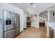 Spacious kitchen that opens into an open floor plan with tile flooring and stainless steel refrigerator at 2674 Tanglewood Trl, Palm Harbor, FL 34685