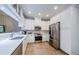 A beautifully designed kitchen featuring white cabinets, stainless steel appliances, and a stylish backsplash at 2674 Tanglewood Trl, Palm Harbor, FL 34685